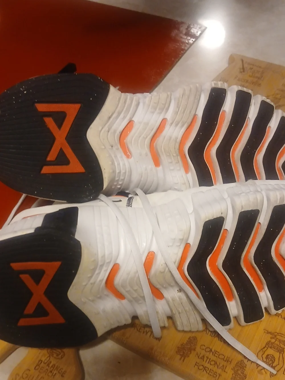 Nike Men’s White Athletic Shoes with Orange and Black Accents